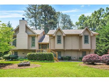 Charming two-story home with wood siding, beautiful landscaping, and mature trees in a desirable neighborhood at 150 Victoria Sta, Woodstock, GA 30189