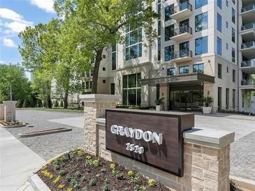 Luxury condo building, Graydon 2520, with elegant landscaping and brick entryway at 2520 Peachtree Nw Rd # 403, Atlanta, GA 30305
