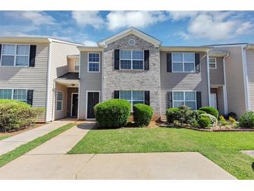 Charming townhome featuring a well-manicured lawn and neutral siding at 2530 Marlin Dr, Mcdonough, GA 30253
