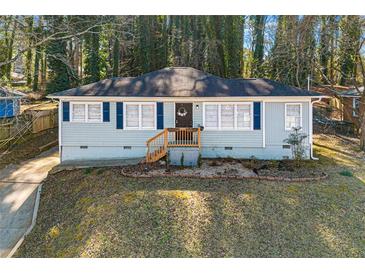 Charming single-story home with blue shutters and a welcoming front porch in a wooded neighborhood at 3723 Glenwood Rd, Decatur, GA 30032