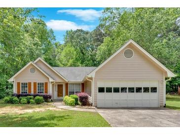 Charming single-Gathering home featuring a well-maintained lawn and attached two car garage at 3663 Homewood Trl, Powder Springs, GA 30127
