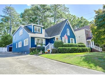 Charming blue two-story home with a landscaped front yard and a welcoming entrance at 2195 Edison Ne Ave, Atlanta, GA 30305