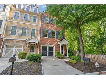 Charming townhome with well-manicured landscaping, front-entry garage, and inviting entrance at 2329 Marion Walk Se Dr # 5, Atlanta, GA 30339