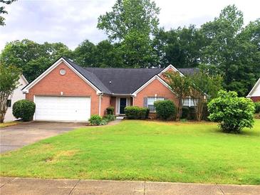 Charming one-story brick home features a well-manicured lawn and attached two-car garage at 75 Saltcreek Pt, Sugar Hill, GA 30518