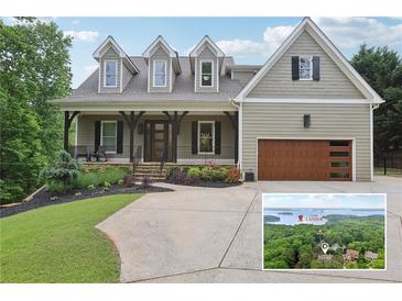 Charming two-story home with a landscaped front yard and a view of Lake Lanier at 7540 Shadburn Ferry Rd, Cumming, GA 30041