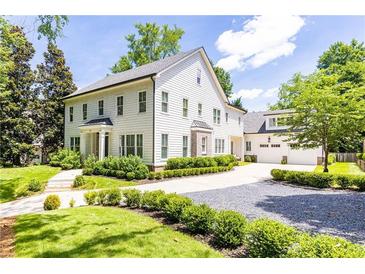Elegant two-story home boasts manicured landscaping and a charming gravel driveway at 4015 Wieuca Ne Rd, Atlanta, GA 30342