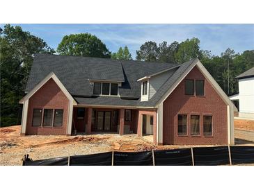 New construction brick home showing architectural details, windows, and a newly installed roof at 101 Deer Canyon Dr, Auburn, GA 30011