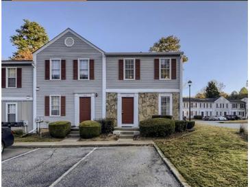 Charming townhouse featuring stone accents, red shutters, and well-maintained landscaping at 3414 Bayshore Dr, Atlanta, GA 30340