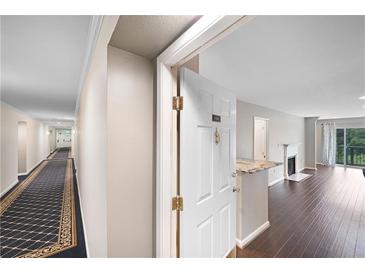 Inviting entryway featuring hardwood floors and a view into the living area with a fireplace at 1312 Pine Heights Ne Dr, Atlanta, GA 30324