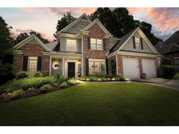 Charming two-story home with brick accents, manicured lawn, and lush landscaping at 4170 Haynes Mill Nw Ct, Kennesaw, GA 30144