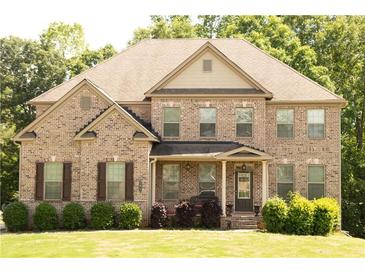 Charming brick home with well-maintained landscaping and inviting front porch at 305 Anise Ct, Mcdonough, GA 30252