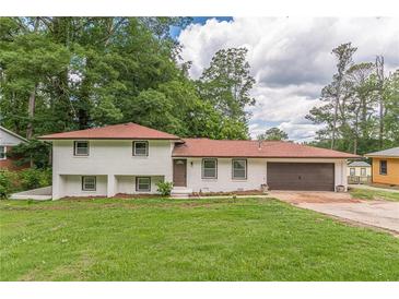 Charming two-story home with a brick exterior, well-manicured lawn, and a two-car garage at 3275 Clifton Church Se Rd, Atlanta, GA 30316