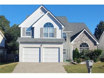Charming two-story home with a two-car garage, stone accents, and well-maintained landscaping at 245 Vaness Dr, Mcdonough, GA 30253
