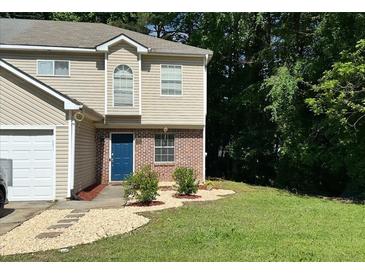 Charming two-story home features a blue front door, partial brick facade, and a well-manicured lawn at 3753 Soapstone Rd, Decatur, GA 30034