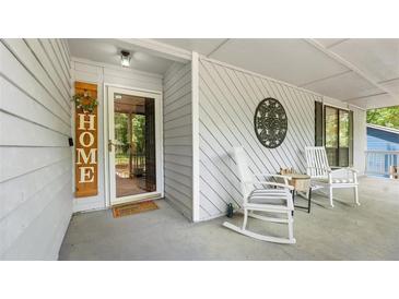 Inviting front porch with rocking chairs, decor, and a welcoming entrance at 4771 Pinefield Nw Dr, Acworth, GA 30102