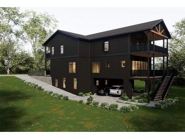 Modern three-story home with a two-car garage, manicured lawn, and multi-level balconies at 984 Sycamore Dr, Decatur, GA 30030