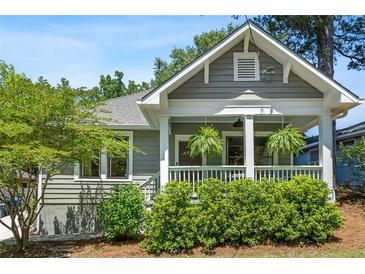Charming craftsman-style home with a welcoming front porch and lush landscaping, perfect for relaxing and enjoying the outdoors at 1116 United Se Ave, Atlanta, GA 30316