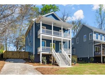 Charming two-story home featuring a double front porch, steps to the entry, and beautiful landscaping at 1183 Mobile Nw St, Atlanta, GA 30314