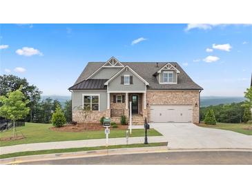 Charming two-story home with stone and siding, a well-manicured lawn, and an attached two-car garage at 231 Laurel Vista Dr, Canton, GA 30114