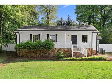 Charming renovated home with stone foundation, white picket fence, and fresh landscaping at 2849 Knotty Pine Ct, Buford, GA 30519