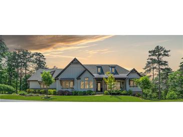 Stunning single-story home with beautiful architecture and mature landscaping under a picturesque sky at 23 Sunset Se Rdg, Cartersville, GA 30121