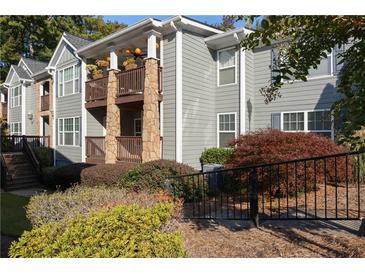View of the condo's exterior showcasing the building's architectural details and landscaping at 1102 Madison Ln # 1102, Smyrna, GA 30080