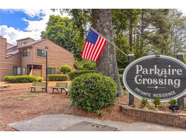 Parkaire Crossing community sign in a private residence with an American flag in the yard at 907 Parkaire Xing, Marietta, GA 30068