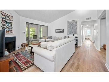 Bright living room features a fireplace, sliding glass doors, and modern decor at 907 Parkaire Xing, Marietta, GA 30068