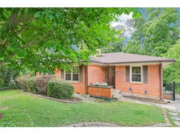 Charming brick home with well-manicured lawn and mature trees at 845 Stratford Rd, Avondale Estates, GA 30002