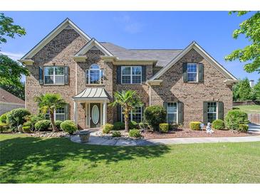 Stately brick home featuring a landscaped front yard and a welcoming entrance at 4765 Smokestone Dr, Douglasville, GA 30135