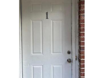 Apartment front door with white paint and the number one on the front at 1651 Massachusetts Sw Ave # 1, Marietta, GA 30008