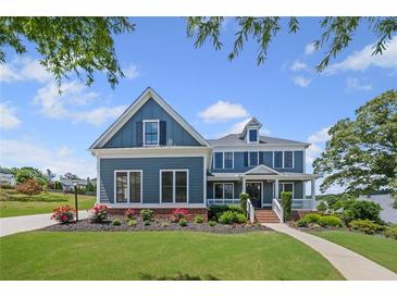 Beautiful two-story blue house with landscaped front yard and inviting entryway, offering charm and curb appeal at 4035 Pinebrook Cir, Cumming, GA 30028