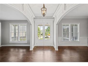 Inviting foyer with hardwood floors, classic millwork, arched openings, and bright, natural light at 4035 Pinebrook Cir, Cumming, GA 30028