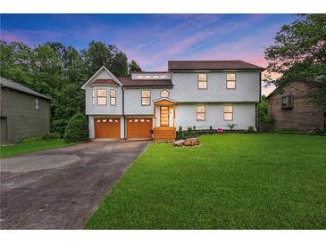 Charming two-story home with a well-manicured lawn, two car garage and covered entry at 1105 Sallete Ct, Marietta, GA 30066