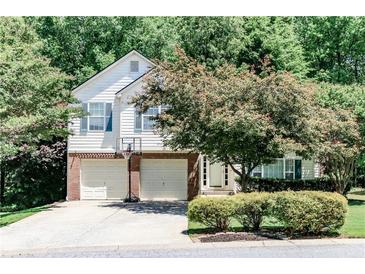 Charming two-story home featuring a two-car garage and well-maintained landscaping in a lush, green neighborhood at 2204 Dresden Nw Grn, Kennesaw, GA 30144