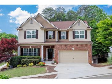 Charming two-story home with brick accents, a well-manicured lawn, and a two-car garage at 139 Lake Reserve Way, Canton, GA 30115