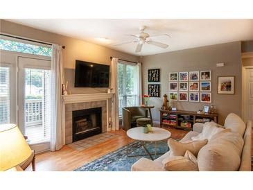 Bright living room features a fireplace, hardwood floors, and plenty of natural light at 1025 Mcgill Park Ne Ave, Atlanta, GA 30312