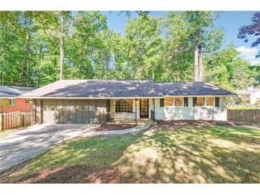 Charming ranch-style home with a well-maintained front yard and attached two car garage at 3708 Canadian Way, Tucker, GA 30084