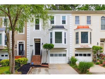 Attractive townhome showcases a stylish facade, well-maintained landscaping, and attached garage at 3910 Meeting St, Duluth, GA 30096