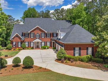 Beautiful two-story brick home with a large driveway and well-manicured landscaping at 219 Eagles Landing Way, Mcdonough, GA 30253