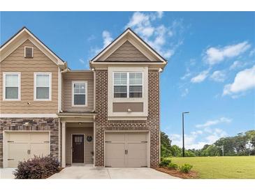 Charming two-story townhome with a brick and siding facade and a well-maintained lawn at 6315 Princeton Ridge Dr, Lithonia, GA 30058