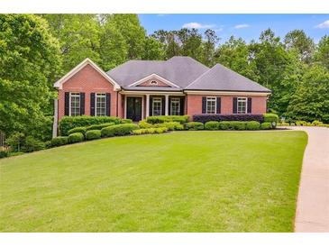 Charming one-story brick home with manicured lawn and mature trees at 7511 Biltmore Ln, Douglasville, GA 30135