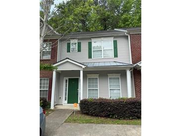Charming townhouse with gray siding, green shutters, and a well-maintained front yard at 20 Pine Canyon Sw Dr # 26, Atlanta, GA 30331