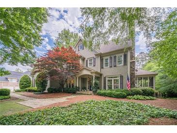 Charming two-story home with beautiful landscaping and an inviting covered front porch at 5650 Buckleigh Pointe, Suwanee, GA 30024