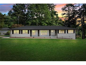 Charming single-story home with a well-manicured lawn and classic architectural design at 2604 Flat Shoals Sw Rd, Conyers, GA 30094