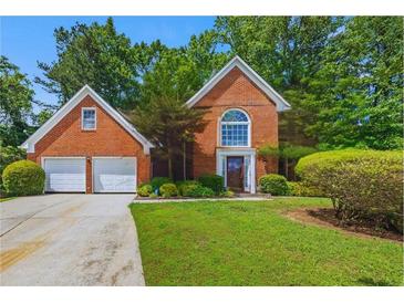 Charming brick two-story home with a well-manicured lawn and a two-car garage at 502 Fortune Ridge Rd, Stone Mountain, GA 30087