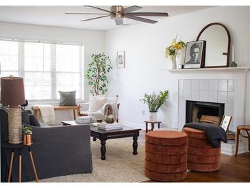Cozy living room featuring a fireplace, neutral tones, and plenty of natural light at 1320 Country Acres Ln, Lawrenceville, GA 30045