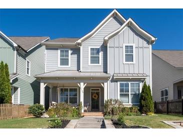 Charming two-story home with a welcoming front porch, manicured lawn and tasteful landscaping at 2100 Drew Nw Dr, Atlanta, GA 30318