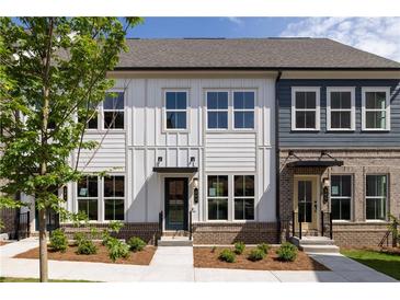 Charming townhome with neutral siding, brick accents, well-manicured landscaping, and dark door frames at 339 Skylar Se Way, Atlanta, GA 30315