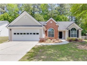 Charming single-Gathering home featuring a two-car garage and landscaped front yard at 2175 Charleston Oak Cir, Lawrenceville, GA 30043